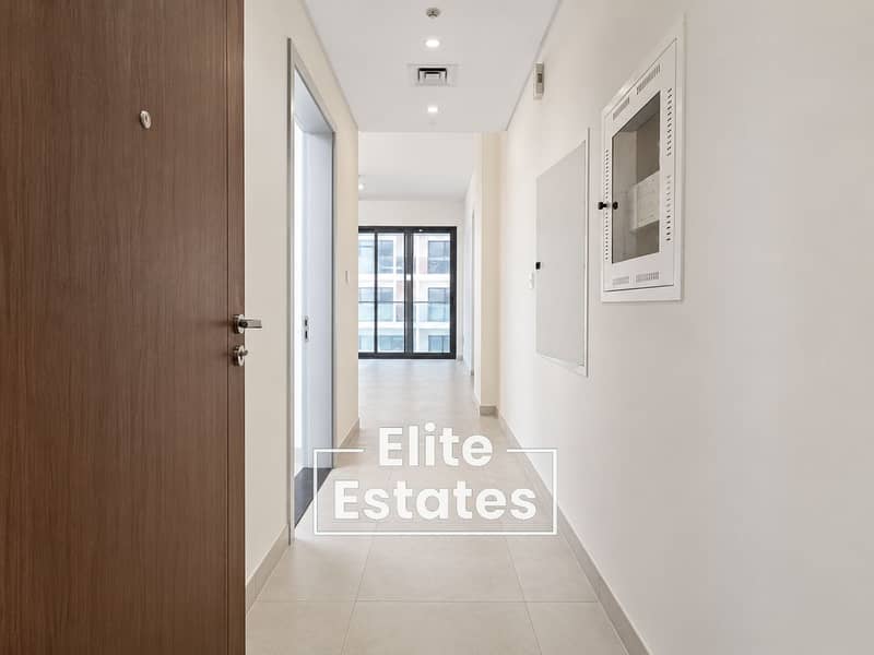 3 Minimalist Apartment Hallway with Windowed Living Space. png