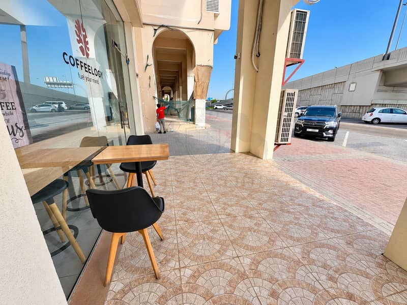 6 Bright Coffeology Arcade Café Street Scene. png