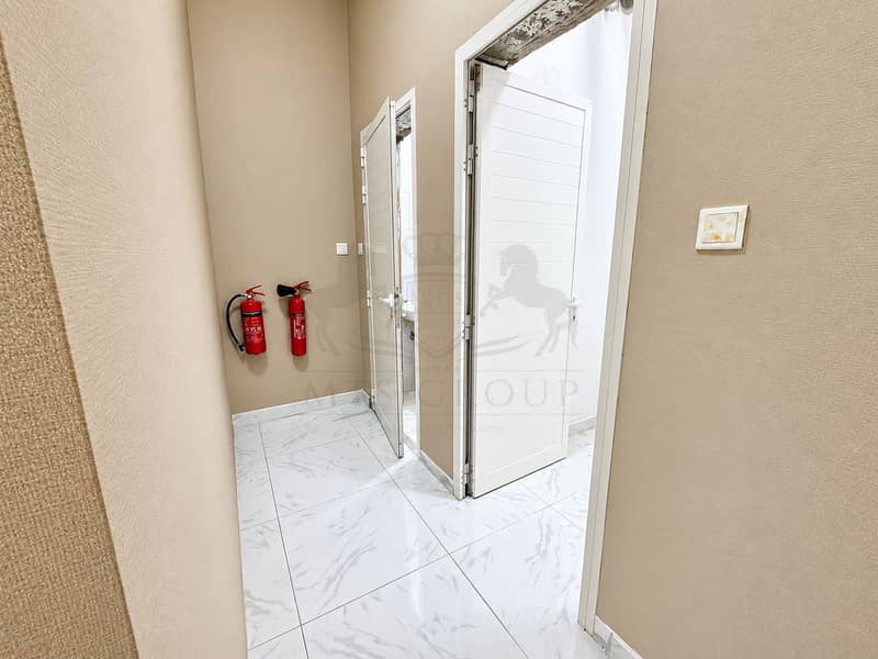 14 Modern Beige Hallway with Fire Extinguishers. png