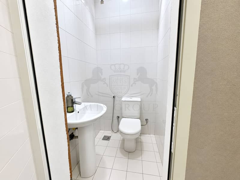 16 Clean White-Tiled Bathroom Interior. png