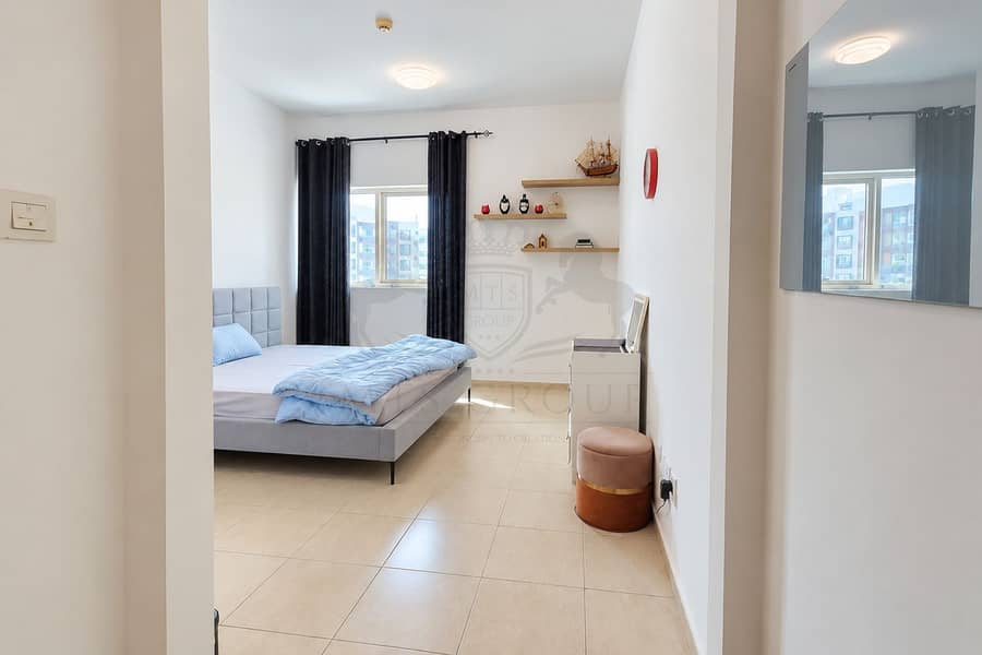 5 Modern Bedroom with Blue Bedding and Window. png