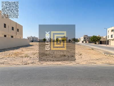 Plot for Sale in Al Manama, Ajman - أرض فضاء بين مبانٍ سكنية. png