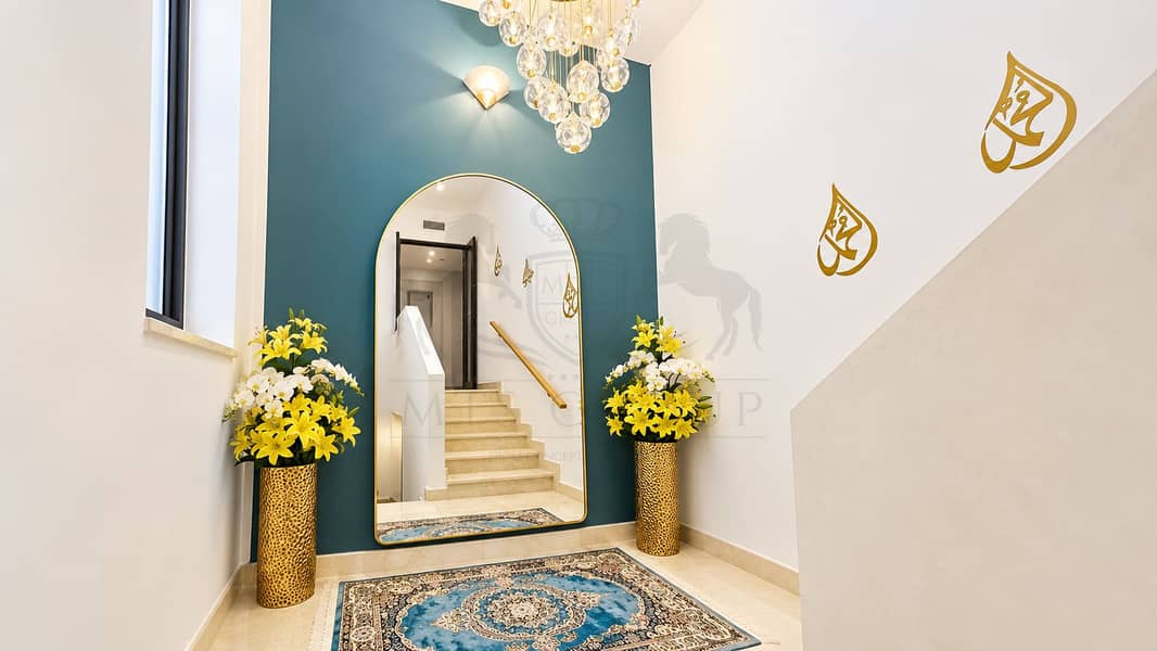 14 Symmetrical Teal Foyer with Arched Mirror. png