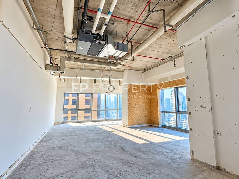 4 Sunlit Unfinished Interior with City Views. png