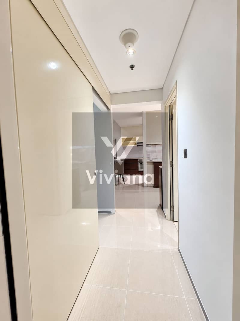 8 Modern Cream-Tiled Hallway to Kitchen. png