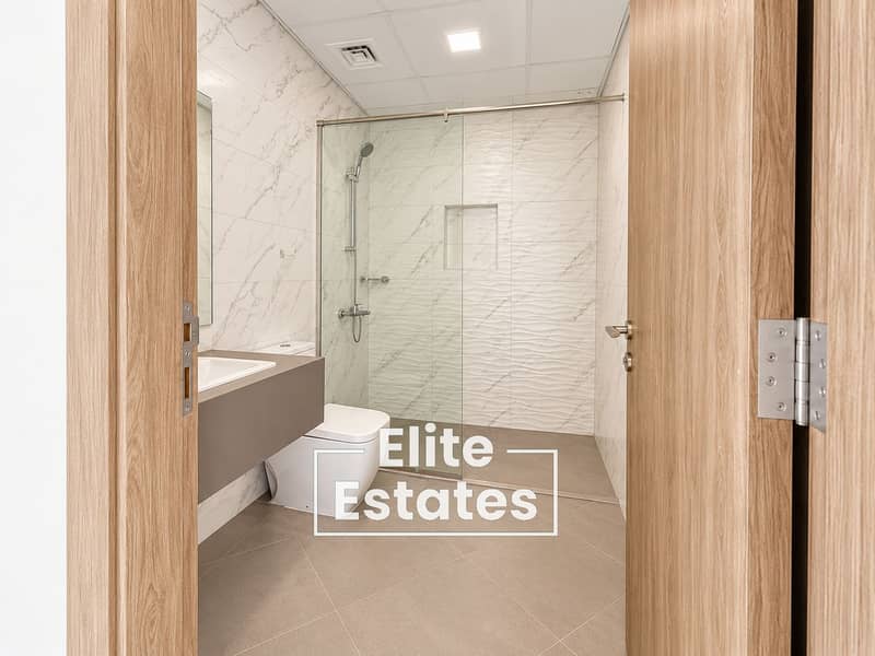 9 Modern Marble Bathroom Through Open Doorway. png