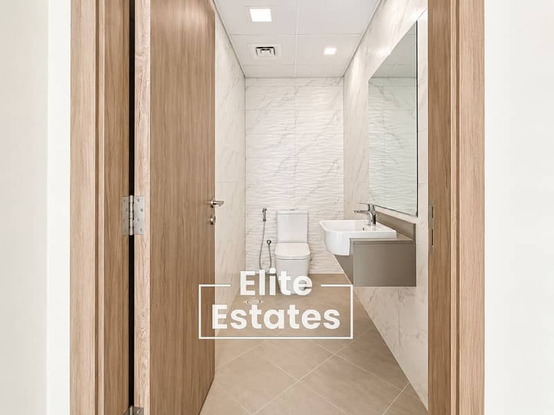 10 Modern Minimalist Bathroom Through Wooden Door. png