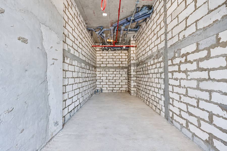 7 Unfinished Utility Corridor with Exposed Pipes. png