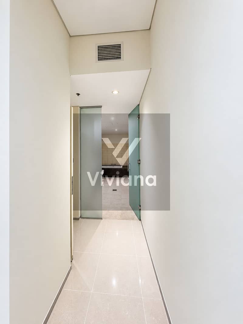 5 Modern hallway leading to a tiled bathroom. png