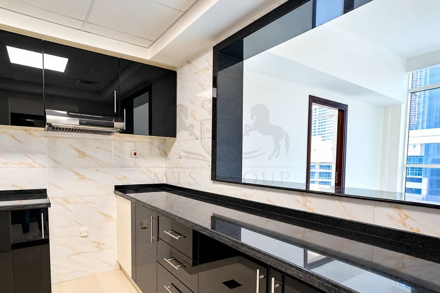 9 Sleek Marble and Glossy Black Kitchen. png