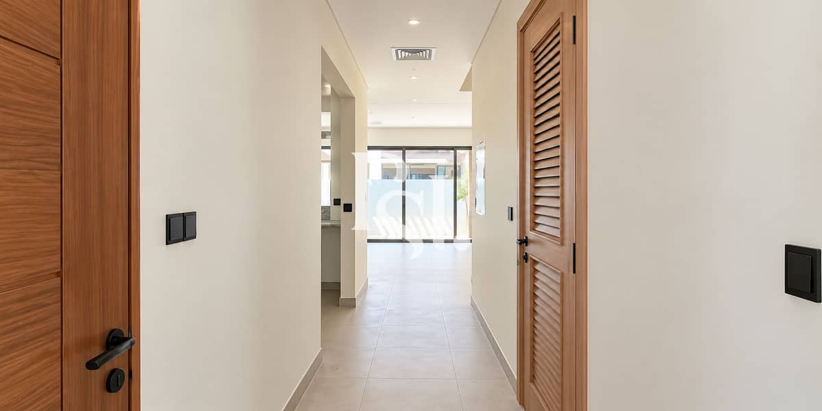 3 Minimalist Hallway Leading to Sunlit Patio. png