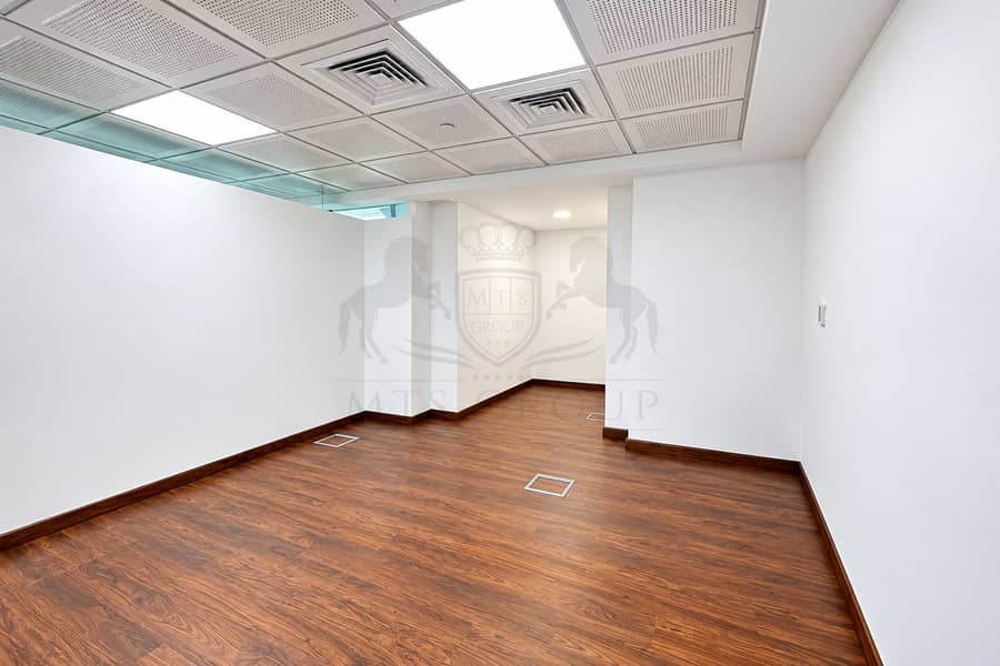 2 Empty Modern Office with Warm Wood Flooring. png