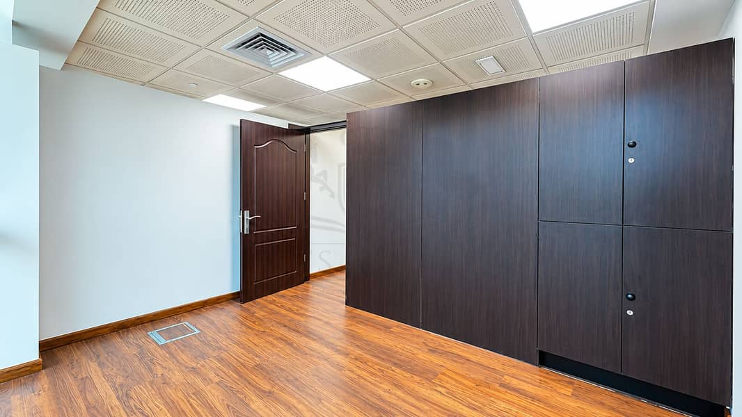 8 Modern Empty Office with Dark Wood Cabinetry. png