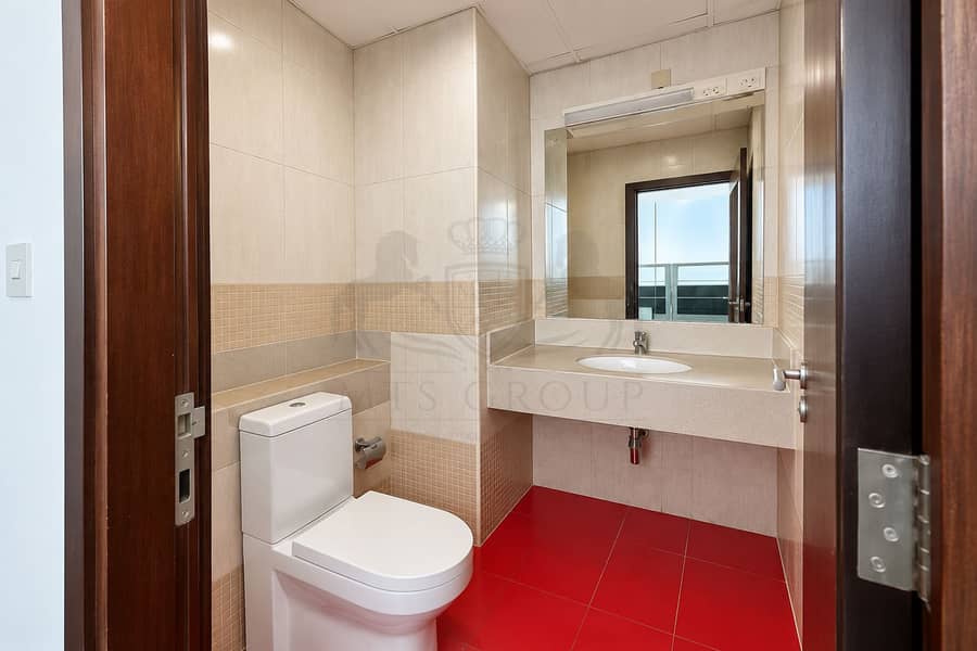 14 Modern Beige Bathroom with Red Tile Floor. png