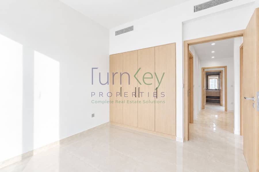 4 Sunlit Minimalist Room with Pale Wood Closets. png