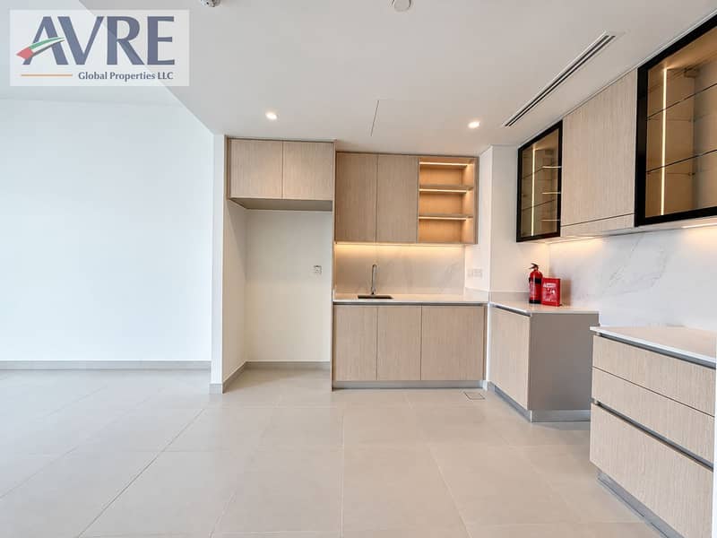 4 Modern minimalist kitchenette with oak cabinetry. png