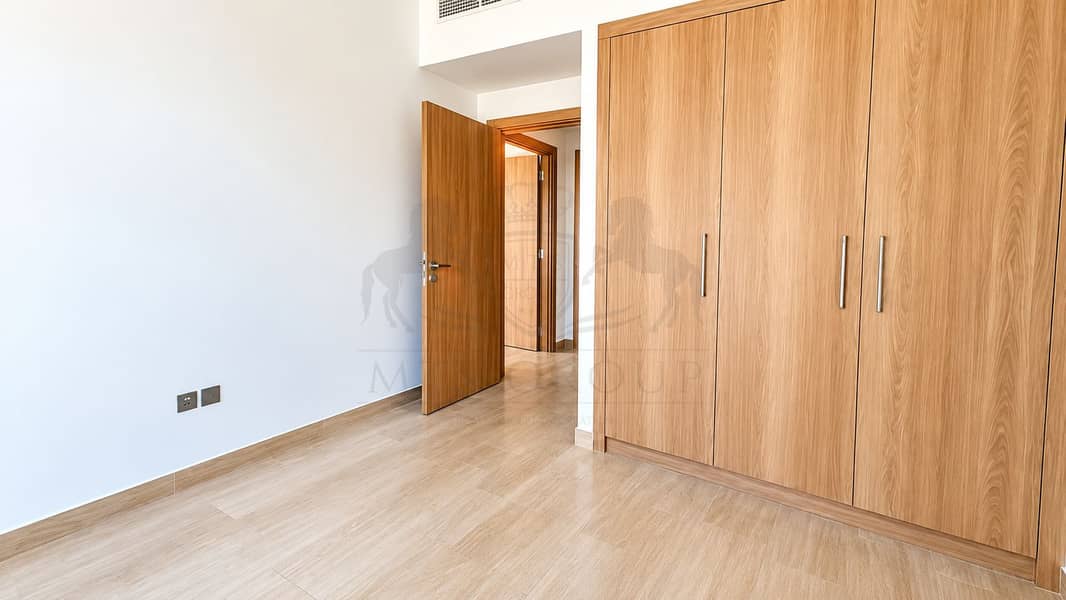 2 Bright Minimalist Bedroom with Oak Wardrobe. png