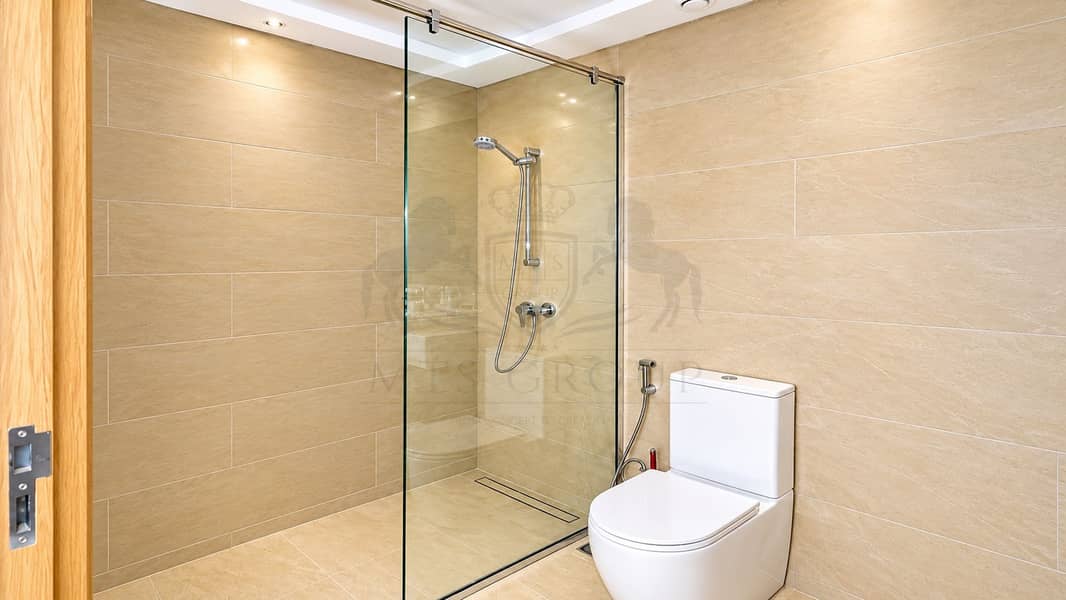 14 Modern Beige-Tiled Bathroom with Glass Shower. png