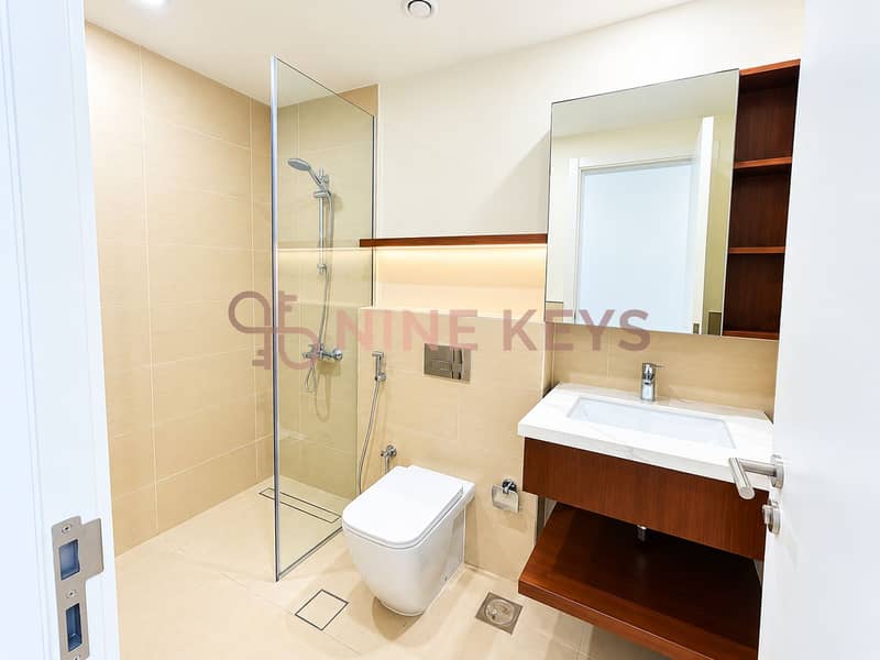 10 Modern Beige-Tiled Bathroom with Warm Wood Accents (1). png