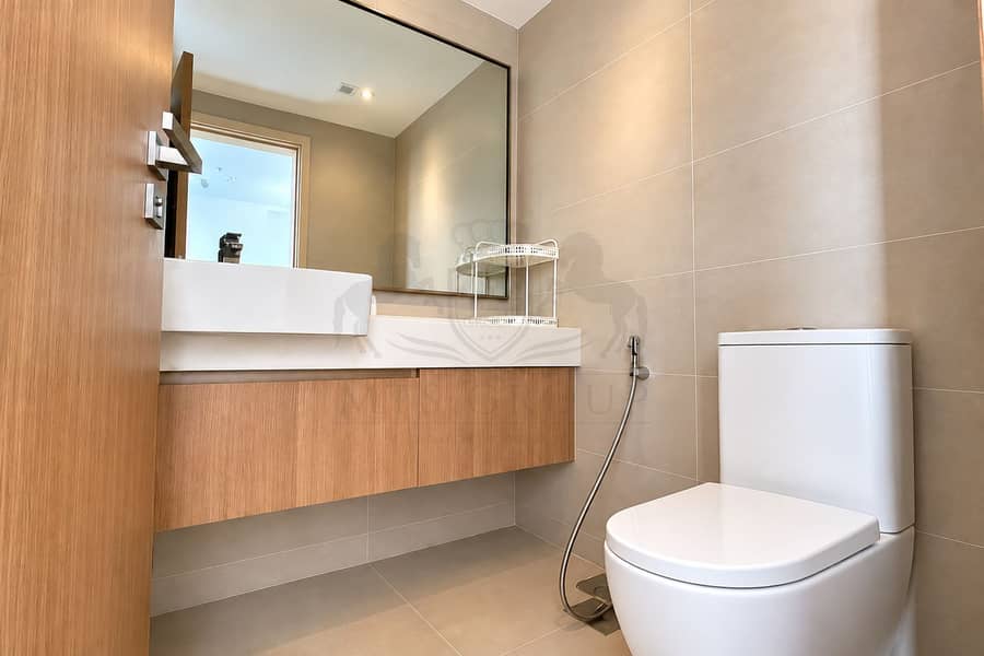 12 Modern Beige Bathroom with Closed-Lid Toilet. png