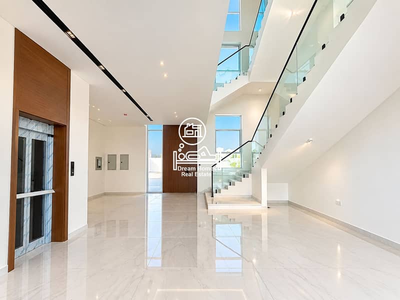 6 Luxurious Minimalist Foyer with Glass Staircase. png