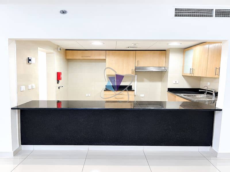 10 Modern Kitchen Pass-Through with Black Granite Countertops. png