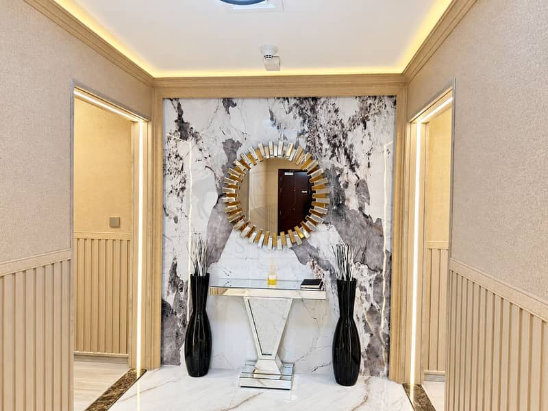 10 Symmetrical Marble Foyer with Sunburst Mirror. png