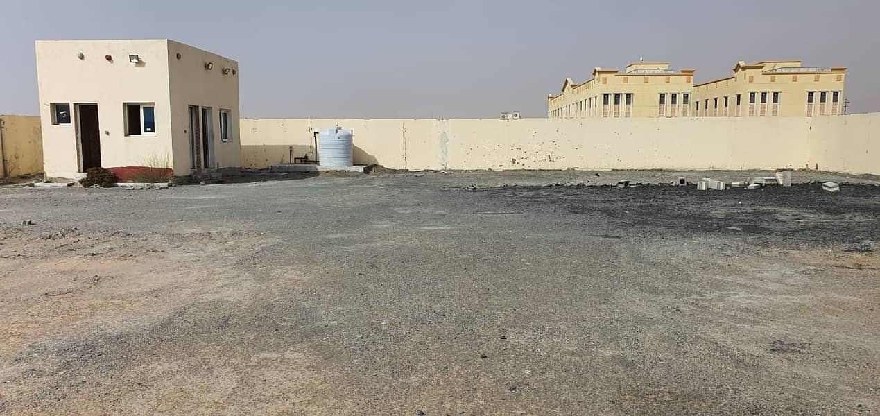 20,000 sq ft open land with high boundary wall, builtin office and toilets in Sajja Industrial area, Sharjah