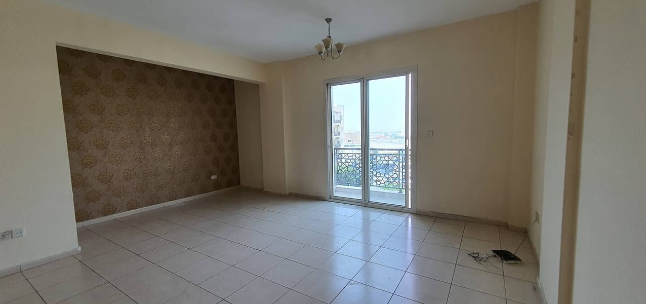 LARGE STUDIO EMIRATES CLUSTER AVAILABLE FOR RENT WITH BALCONY  IN INTERNATIONAL CITY ONLY 19,000 YEARLY