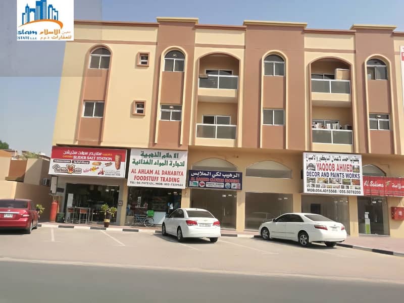 Large and different commercial stores on a main street for rent in Ajman.