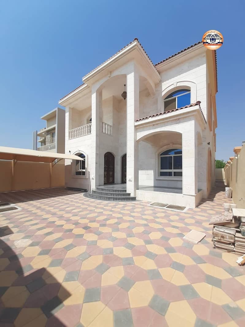 Villa for sale in Ajman, the Rawda area, with a stone face, central air conditioning, personal finishing, close to services