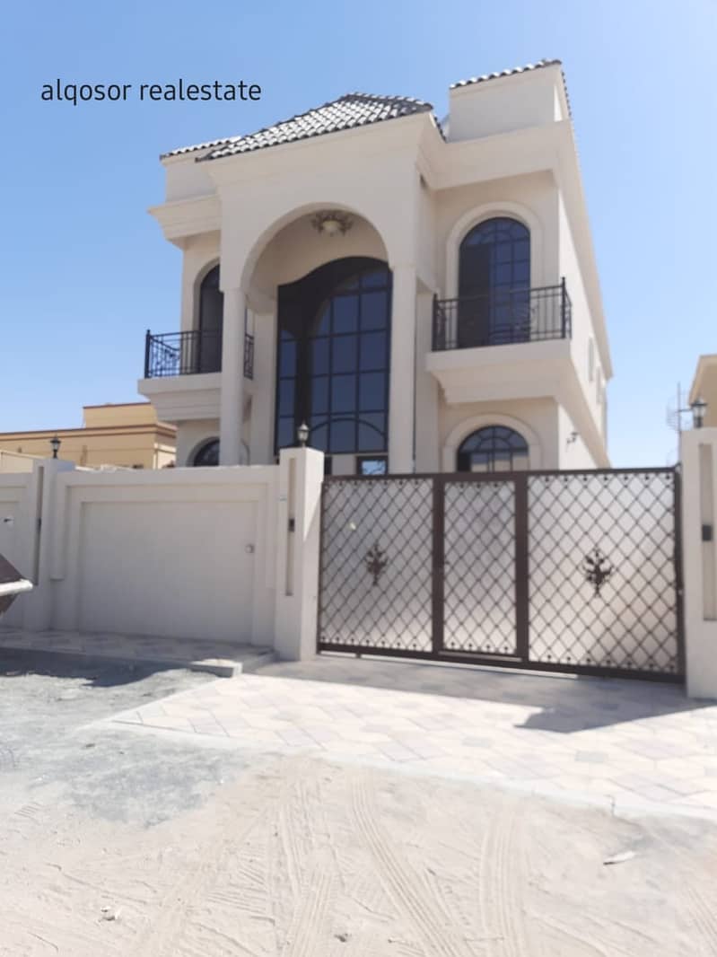 For sale villa near a main street in Al Mowaihat, freehold for all nationalities, with a price, a privileged location, and a large building area