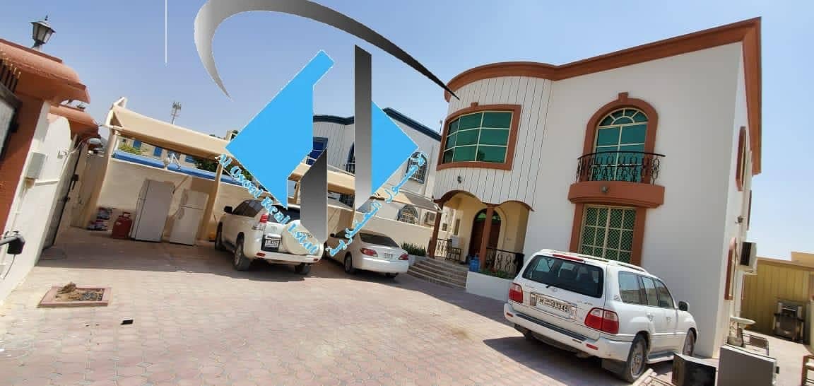 A two-storey villa of 5000 feet with water and electricity in Al Rawda consisting of five master rooms, a majlis, a hall, a servants room, a main kitchen and a parking lot for cars